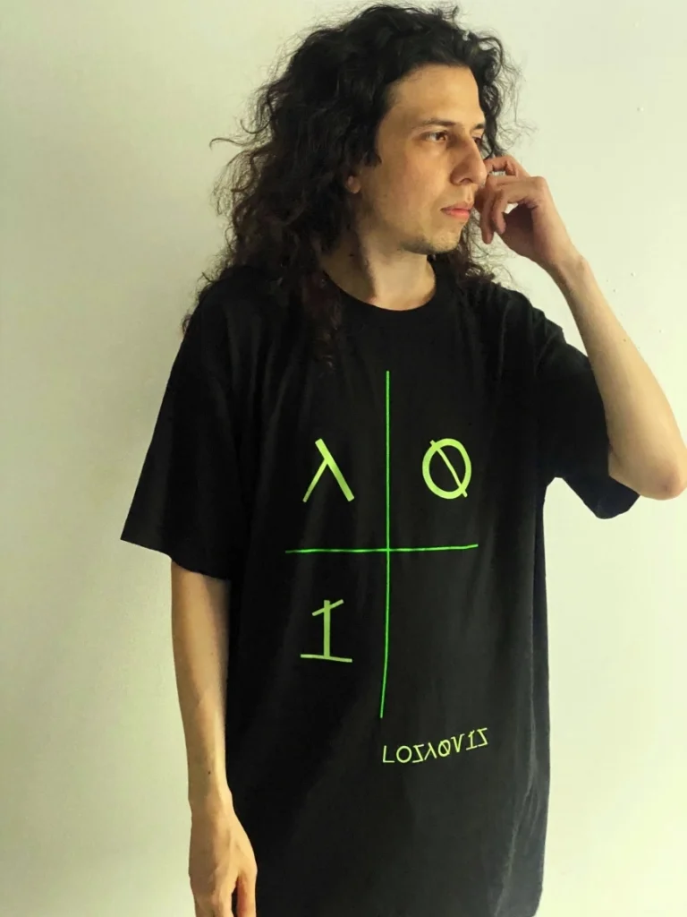 Man wearing a minimal tech t-shirt from Losaquis against a white background, showcasing alternative fashion and alien-inspired streetwear