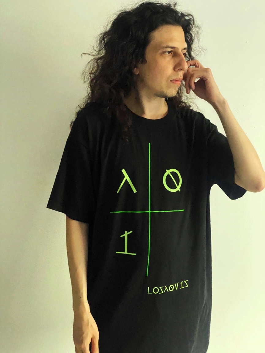 Man wearing a minimal tech t-shirt from Losaquis against a white background, showcasing alternative fashion and alien-inspired streetwear