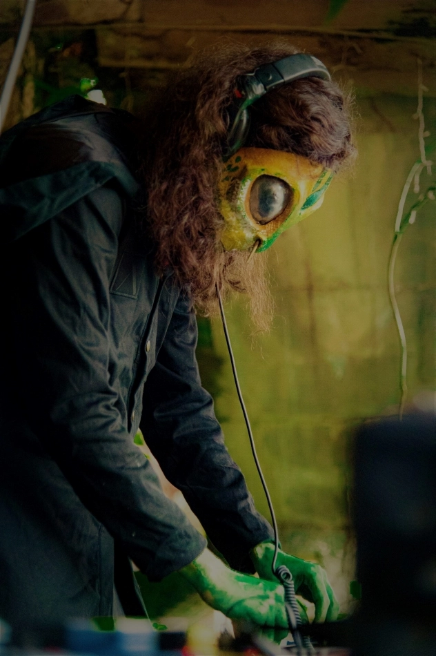 Dagan from Losaquis playing a Launchkey MIDI controller during an alien ritual live show at Los Girasoles Villavicencio Colombia blending electronic music with ancestral alien aesthetics