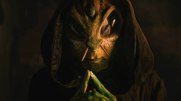 Dagan from Losaquis in an ancestral alien mask, performing a mystical alien ritual that blends ancient traditions with futuristic identity.