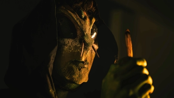 Dagan of Losaquis wearing his aboriginal alien mask, channeling ancestral energy and alien identity during an immersive ritual performance.